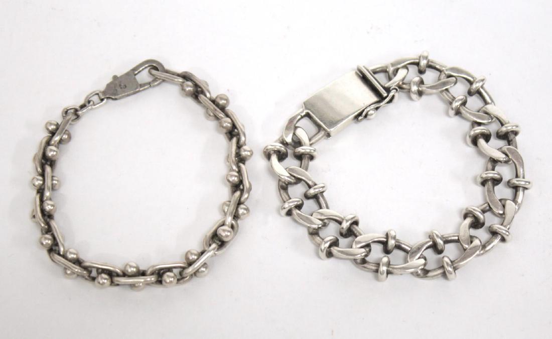 Silver Men's Chain Bracelets, 2 incl. Sterling: Two men's silver bracelets, one sterling curb chain marked "Mex925," the other an elongated chain with double ball bar, tested as silver. Each 9.25" diameter. Approx. 3.8 ozt.