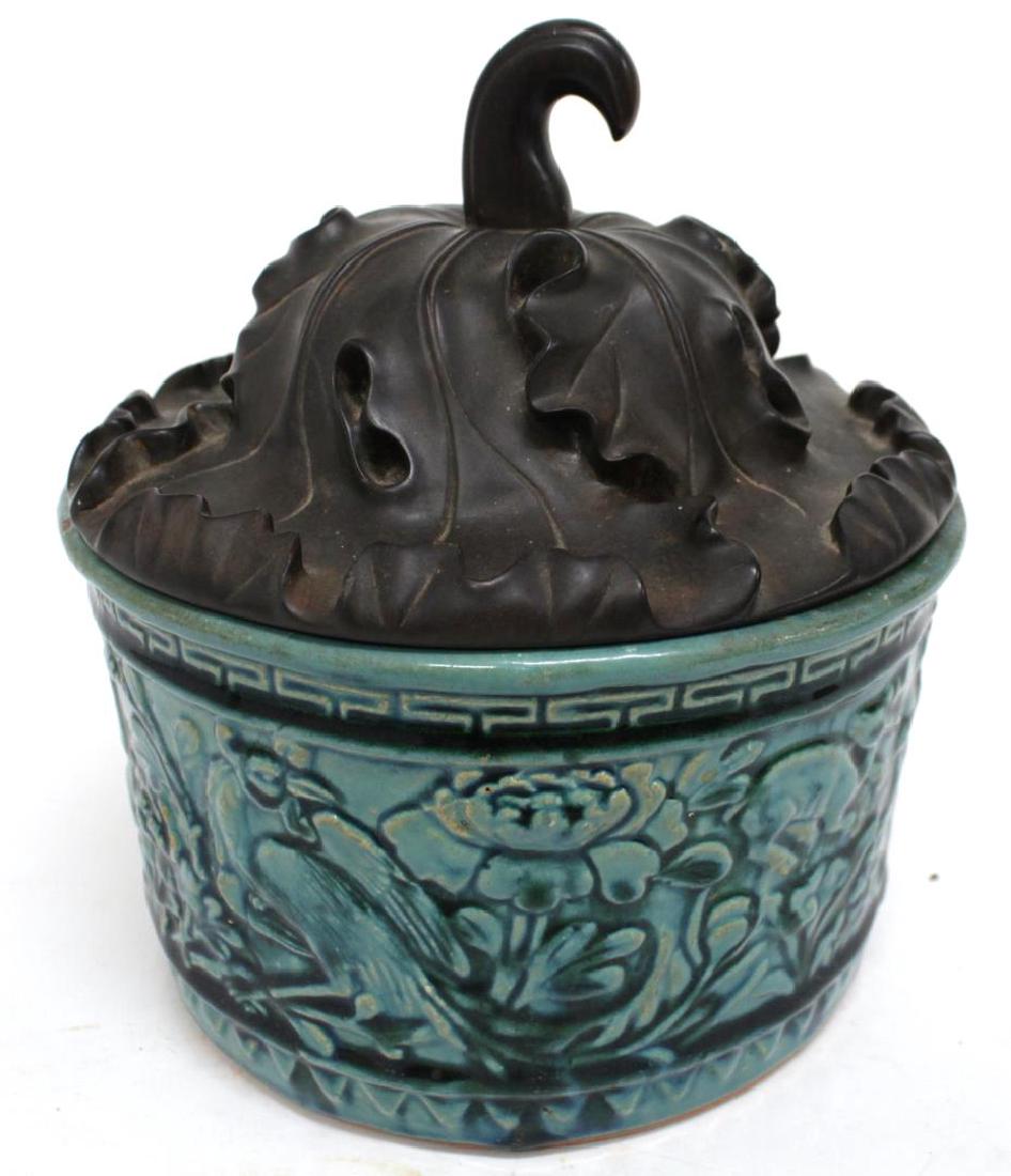 Chinese Glazed Earthenware Jar & Carved Gourd Lid: Chinese ceramic container molded with water weeds, fish, dragons, phoenix, and deer, the hardwood cover carved to resemble the top half of a leafing gourd. 9" H.