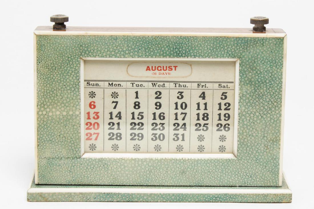English Art Deco Shagreen Perpetual Calendar: English Art Deco perpetual calendar, vintage circa 1925, designed by W.J. Myatt & Co., Birmingham, covered in green shagreen with bone banding, and two turning scrolls of red striping to mark passed d