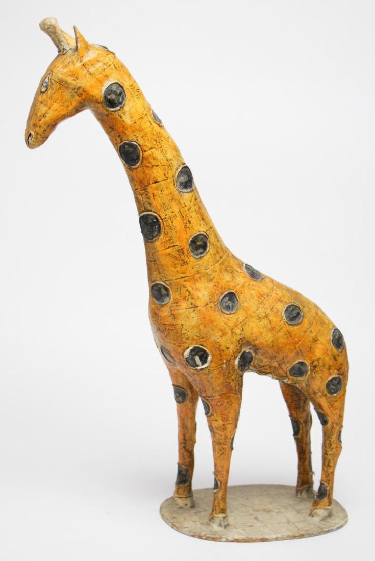 Large Mexican Papier Mache Giraffe Figure: With hand-applied twine spots, the underside with a tag reading "Jeanne Valentine S.A. / Made in Mexico." 20" H X 19" L.