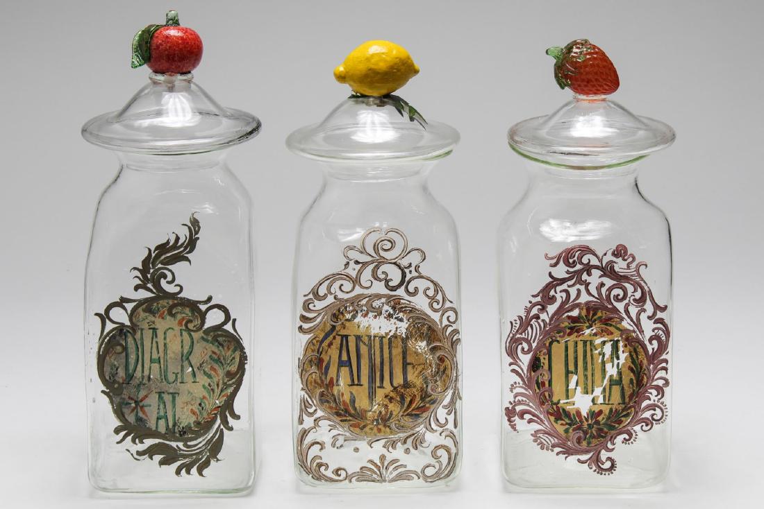 Italian Hand-Blown Glass Kitchen Canister Set, 3: Italian hand-blown and painted glass kitchen canisters, set of three with antique-style painting and glass fruit knops. Each: 13.5" H. Lemon knop a replacement, but the wrapped original is in the cani