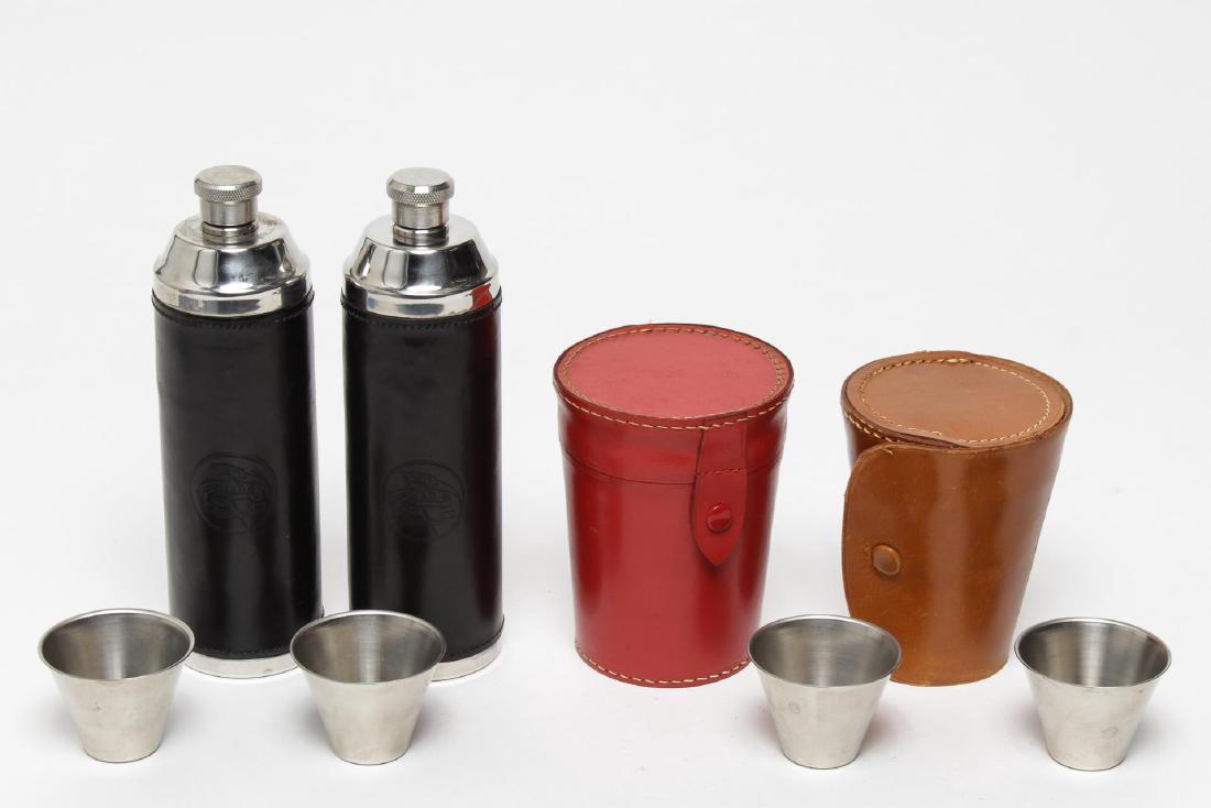 Vintage Leather Cased Flasks & Tumblers, 4: Vintage leather flasks and tumblers, 20th century, two flasks with glass and white metal tumblers. Largest 7.5" H.