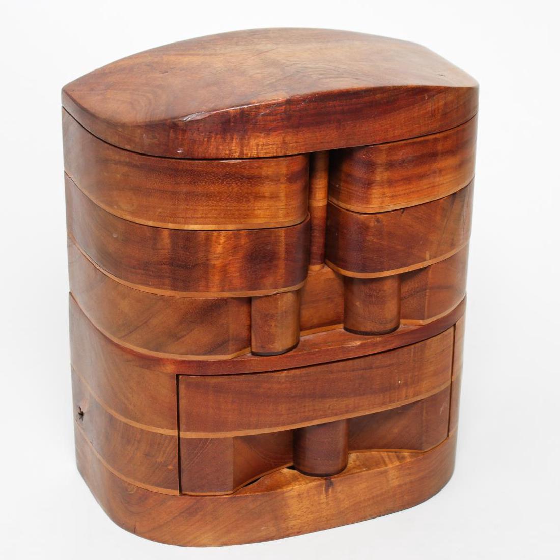 Po Shun Leong (English-American b. 1941)- Wood Box: Po Shun Leong maple wood box, circa 1983, vertical curved form having four swing compartments above a central drawer of six hidden circular compartments. 13.5" H X 11.5" W X 6" D.