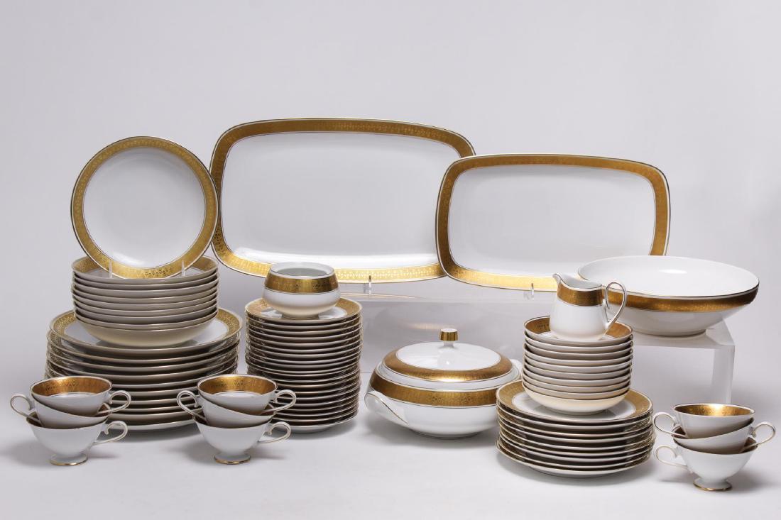 Meissmen German Gilt & White Porcelain Service: Meissmen Bavaria German white porcelain dishware with gilt borders enclosing raised "waves," the undersides with factory marks and stock number "2-815"; approximately 72 pieces. Largest: 15.25" L X 9.