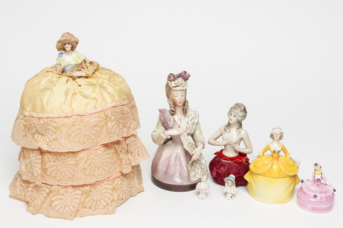Porcelain Dressing Table Figures & Half-Dolls: Vintage porcelain dolls and figurines, 1920s dressing table and other figures of women, comprising an Art Deco pincushion with nude half doll, half doll tea cozy, two miniature half-doll pincushion to