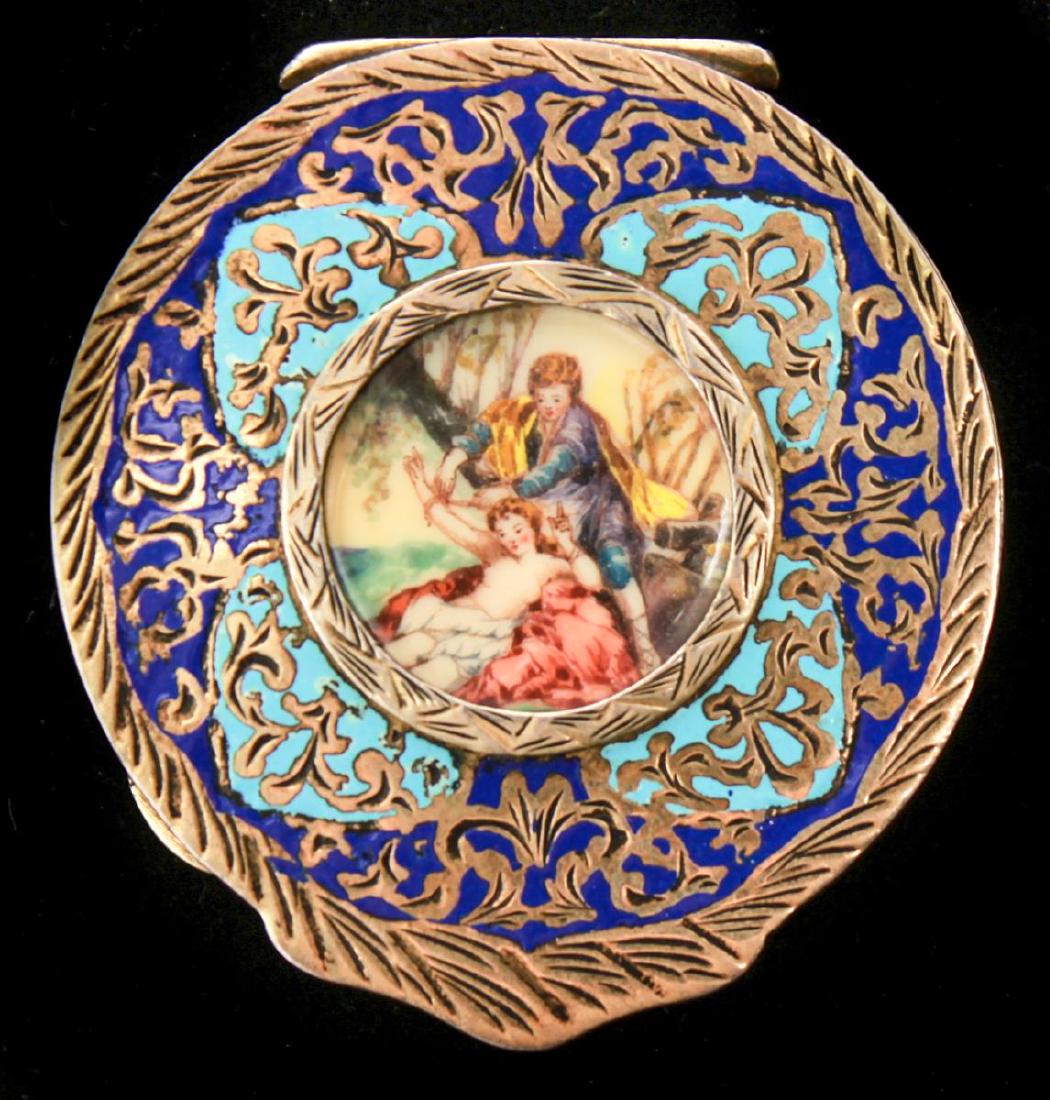 Austrian Silver Gilt Vermeil Enamel Round Compact: Austrian silver gilt vermeil enamel circular compact with beveled mirror, depicting a nude woman and her lover in a landscape, reverse ornately engraved, marked, "800." 2.25" diameter. Not weighable.