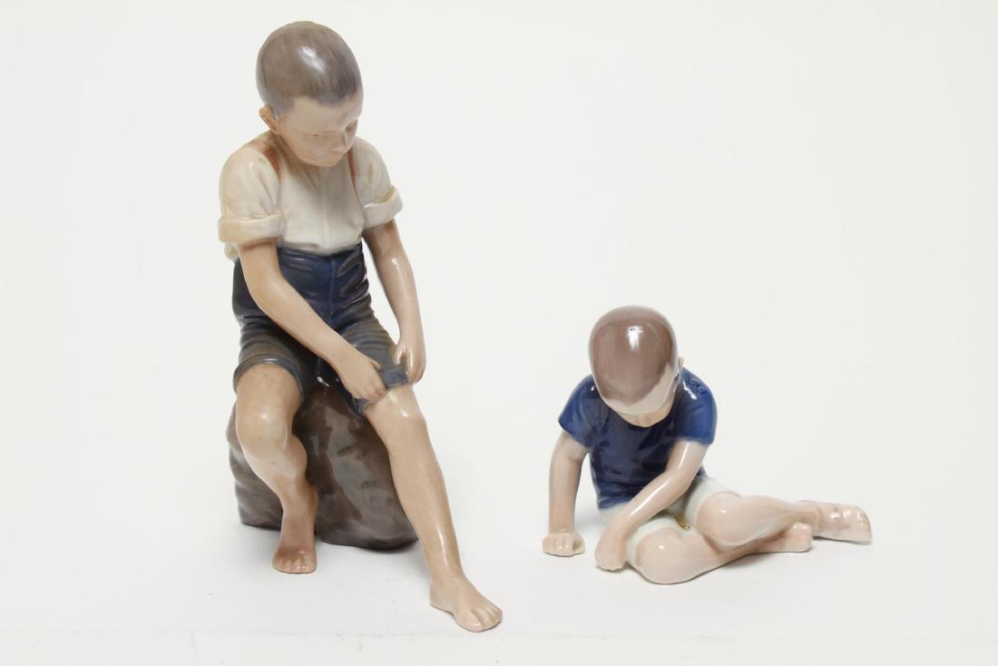 Bing & Grondahl Porcelain Boy Figurines, 2: Bing & Grondahl porcelain boy figurines, comprising "Wading Boy," and "Boy Sitting," all bearing full maker's mark underneath. Largest: 8" H.