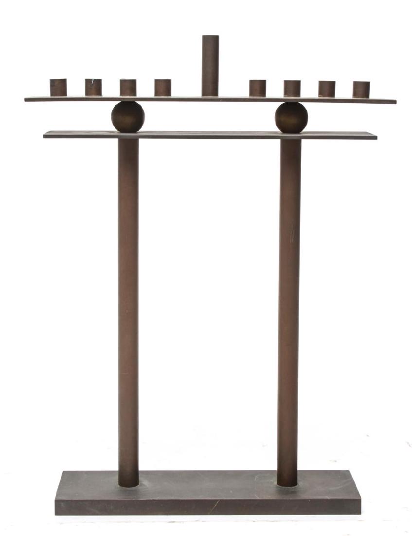 Mid-Century Modern Steel Hanukkah Menorah: Mid-Century Modern patinated steel Hanukkah menorah of architectural form, the eight small taper cups centering a tall shamash. 14" H X 10.5". Some discoloration from wax drippings.