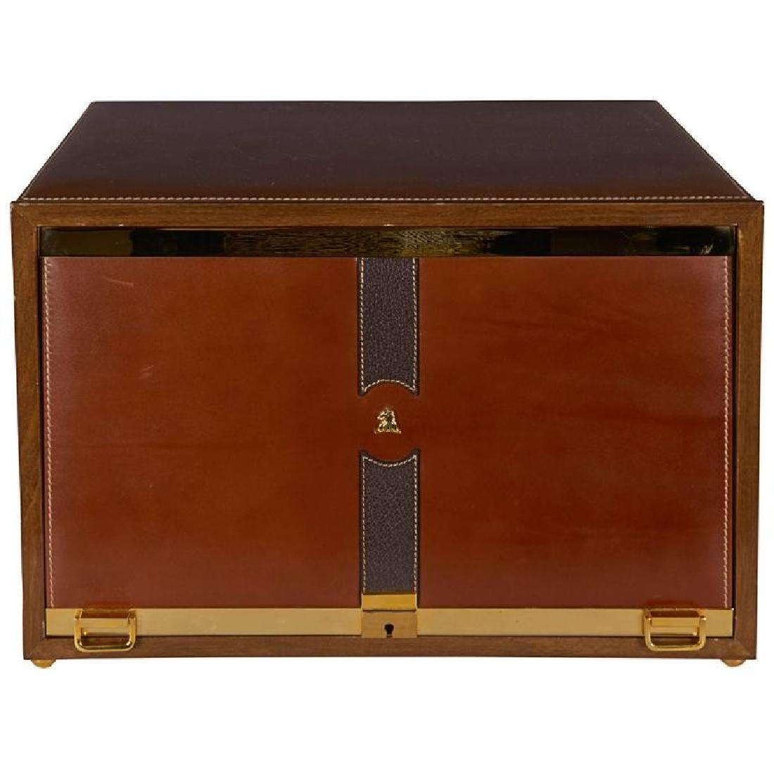 Mark Cross Leather and Brass Men’s Jewelry Box: Mark Cross men’s jewelry box, circa 1980, brown leather with polished brass hardware and handles, locking panel opens to reveal beige suede lined leather front drawers, stamp under base marked with