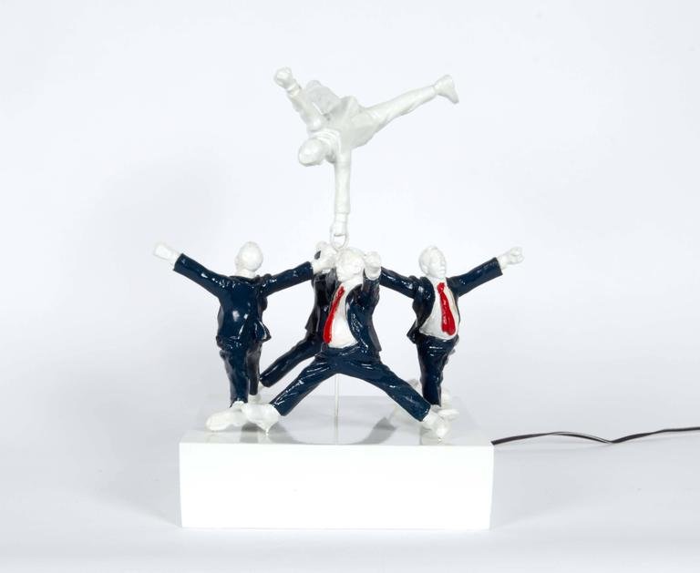 Jeremy Leichman Spinning Ceramic Sculpture: Jeremy Leichman "Middle Management" ceramic sculpture, top figure enabled to spin when plugged in, five male figures in formal work attire, arms and legs splayed in mid-leap, attached to a central bea