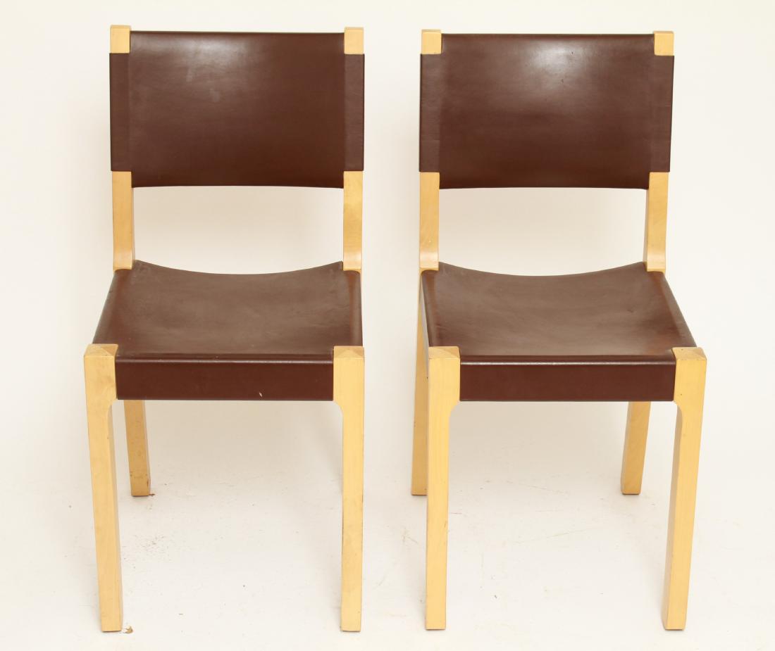Modern "Pelto" Birch & Leather Dining Chairs Pr: Modern "Pelto" dining chairs, birch / wood frames and dark brown leather seats and backs, labels underside, "Made in Italy / Distributed by Ikea of Sweden." 31.5" H x 15.25" W x 16" D. From the Estate