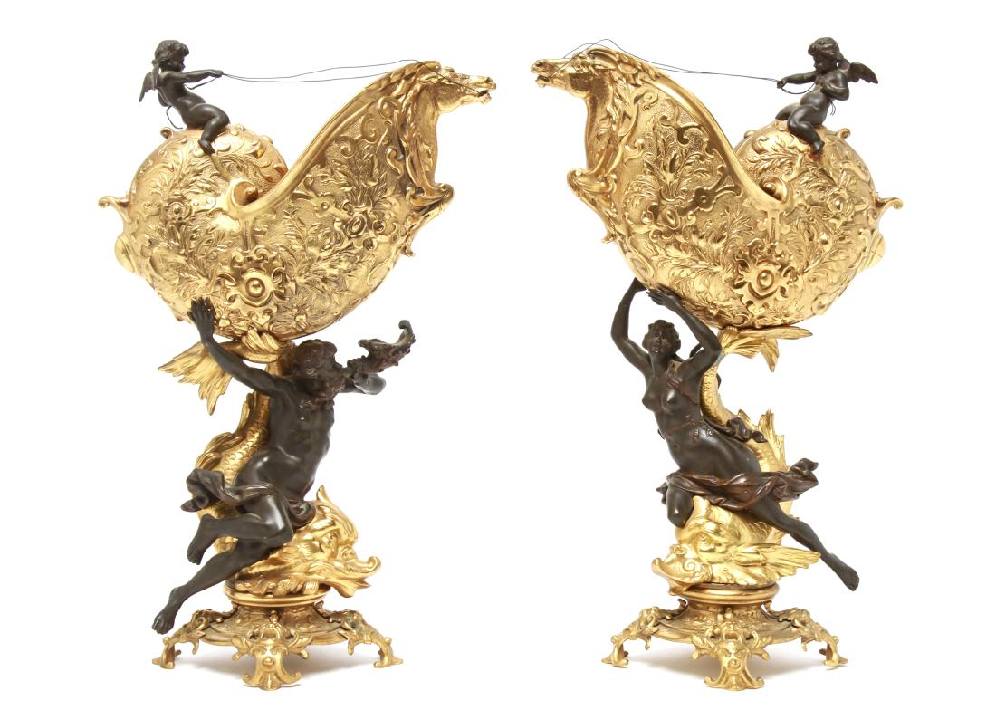 Dore Gilt Bronze Nautilus Figurative Sculptures Pr: Pair of French Rococo / Baroque manner Dore gilt-bronze ormolu nautilus shell vases with horse heads and mounted patinated bronze winged cherubs and nude figurative sculptures depicting Poseiden and t