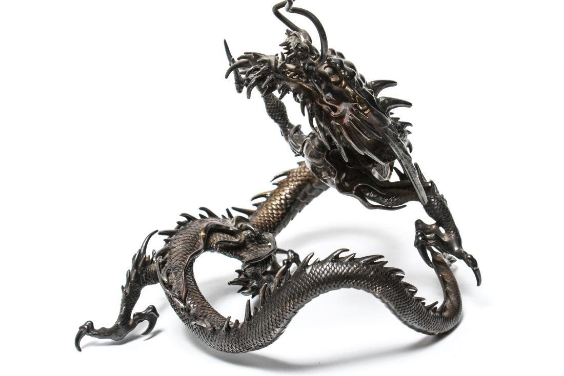 Japanese Meiji Silver Dragon Sculpture Signed: Japanese Meiji Period silver coiled dragon sculpture, illegibly signed 19th century, illegible signature near back legs.11" H x 7" W x 8" D. Approx. 35.53 ozt.