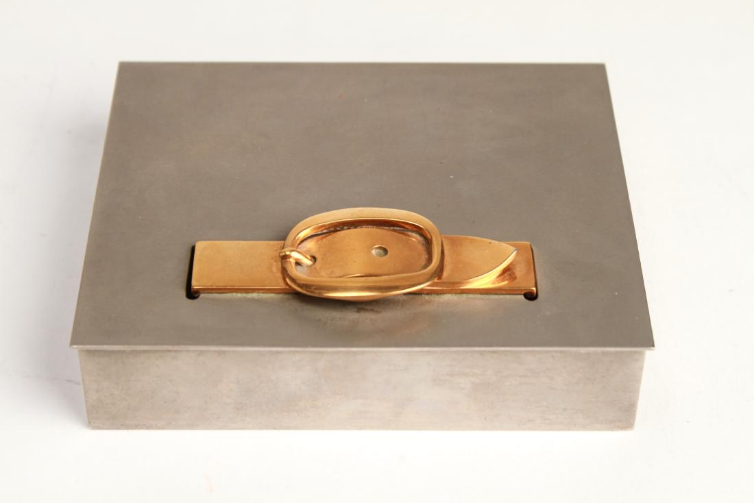 Hermès Paris Silver-Tone Buckle Lidded Box Vintage: Vintage Hermès Paris silver-tone and gold-tone metal buckle lidded box, maker's mark and impressed manufacturer's mark to underside, "Hermès Paris / 61 / Made in France" 1.5" h x 4.75 W x 4" D.