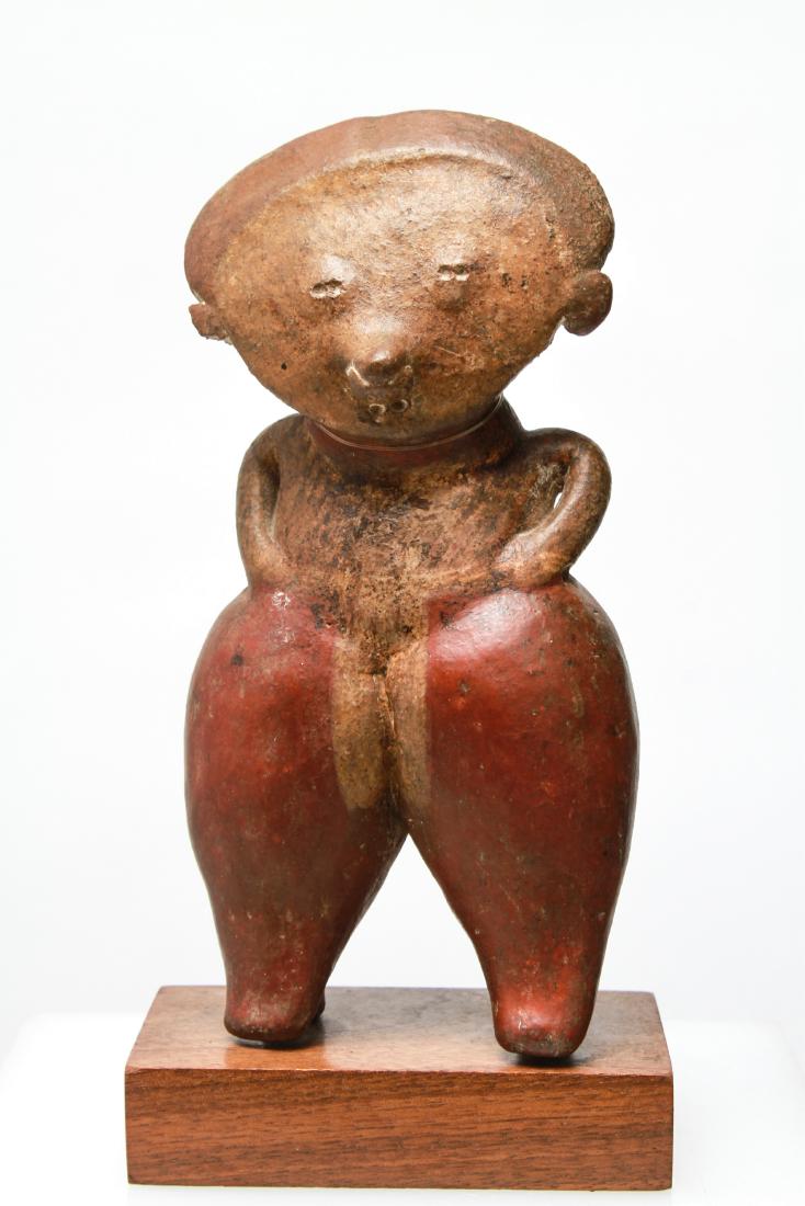 Pre-Columbian Terracotta Standing Figure: Pre-Columbian terracotta standing figure, hands on hips and conical legs with pigment decoration on wood base, possibly Nayarit or Jalisco, Mexico. Terracotta figure: 6.75" H; with base: 7.75" H. From