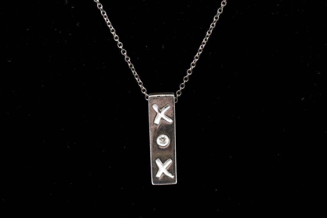 P. Picasso Tiffany & Co. Silver & Diamond Necklace: Paloma Picasso Tiffany & Co. "XOX" sterling silver and diamond pendant necklace, marked: "Paloma Picasso / Tiffany & Co. / 925." Pendant: .75" L; chain: 16" L Approx .15 ozt inclusive. From the Estate