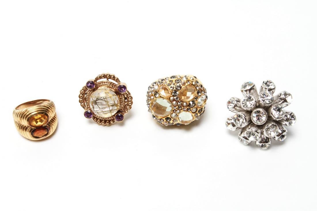 Ladies' Costume Jewelry Rings, Group of 4: Ladies' costume jewelry rings, group of four, comprising one round ring marked "NB India," one with stacked red and yellow stones marked '925,' gold-tone dome ring, and silver-tone ring. Largest: 1.5"