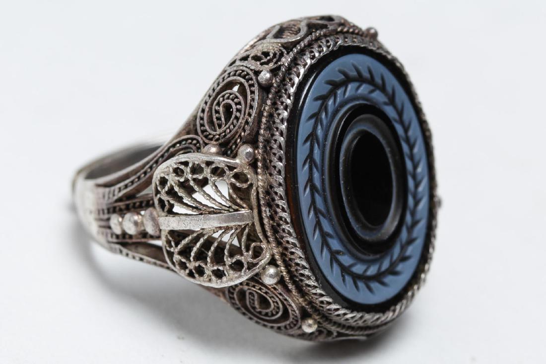 Polish Silver Filigree & Onyx Intaglio Ring: Silver and onyx intaglio ring, Poland, a filigree setting with maker's mark and hallmark of .875-purity. Ring size adjustable, approx. 8.5. Not weighable.