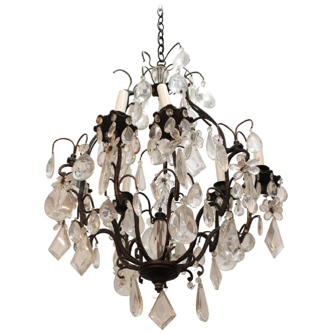 Regency Manner Bronze 9-Arm Chandelier: Regency manner bronze nine arm chandelier, with glass pendant prisms, some faceted. 16" D. Three missing drip dishes.