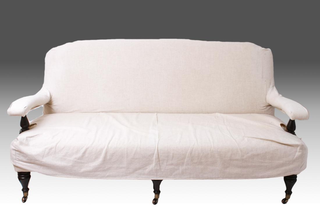 George Smith Open Arm Upholstered Sofa: George Smith modern open arm sofa, off white upholstery with matching slip covers, dark stained wood arms and legs, front legs turned and terminating in casters. 35.5" H x 73" W x 39" D. Minor stains