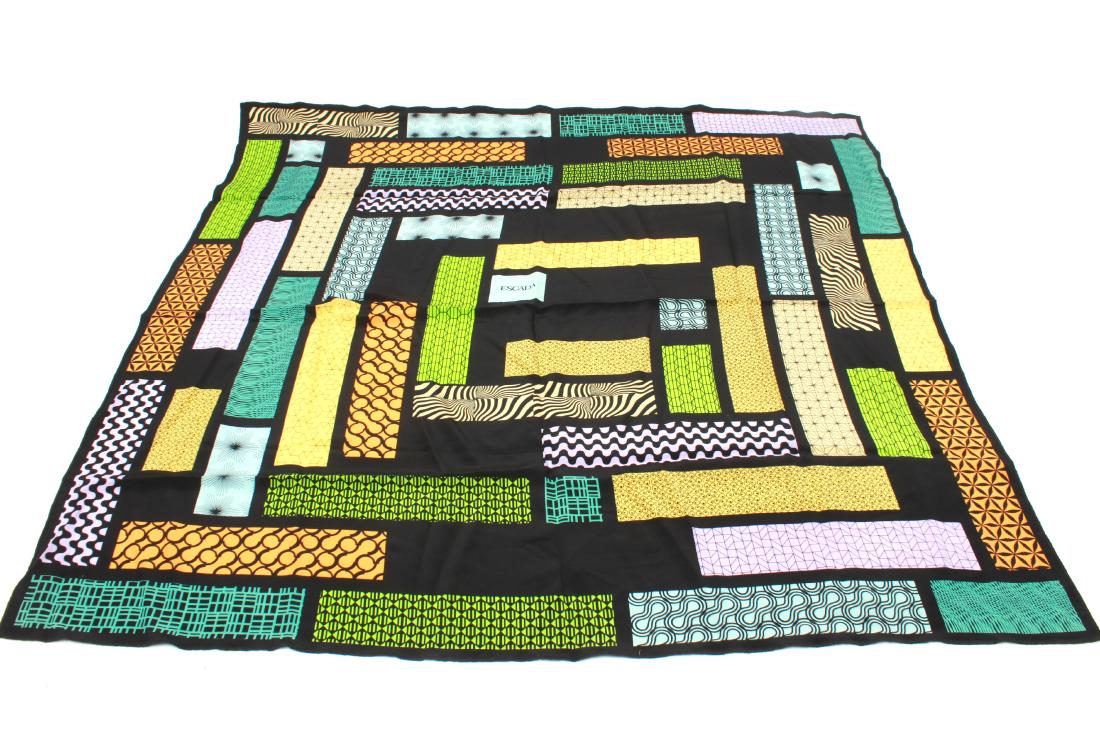Escada Silk Scarf w Geometric Motifs: Escada silk scarf with polychrome panels with geometric motif on black ground, signature panel at center. 34.75" sq.