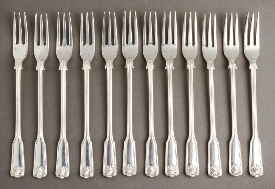 James Robinson Silver Cocktail Forks Set of 12: James Robinson Inc. (1966-2000) sterling silver "Fiddle Thread & Shell" pattern, cocktail / hors d'oeuvre three-tine forks, set of 12, marked: "England / 925 / London / 2000 / JS." 5.625" L. Approx 8.