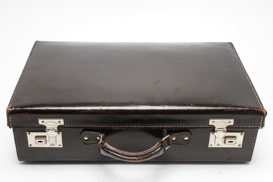Gentleman's Dark Brown Leather Hard Case Briefcase: Gentleman's leather briefcase, hard case in dark brown leather with contrasting stitching, hardware marked "Qualitats-Marke Elephant." 11" H x 17.5" W x 5" D. Some scuffing and usage wear.