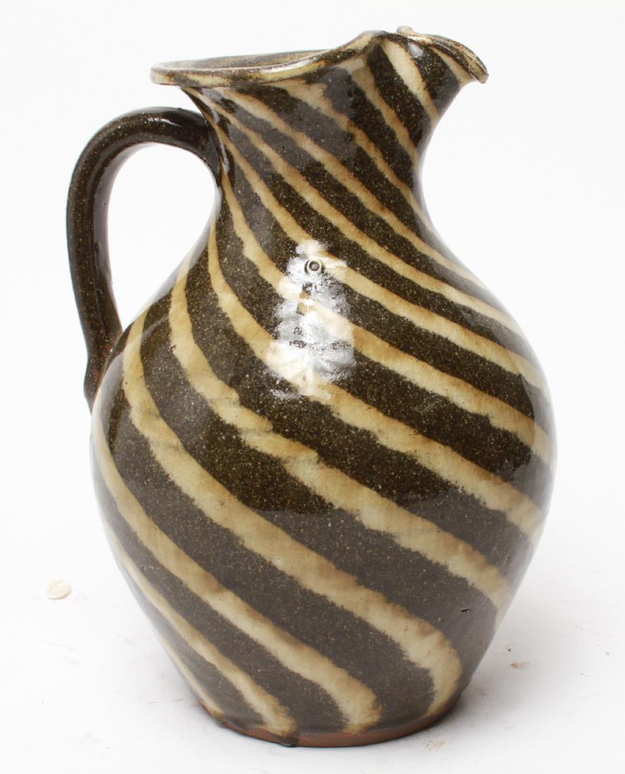 A.V. Smith Folk Art Pottery Striped Glaze Pitcher: A.V. Smith folk art pottery pitcher, glazed stoneware vessel with striped decoration, signed underside "A.V. Smith." 11" H. From the Collection of Actor Ron Rifkin.