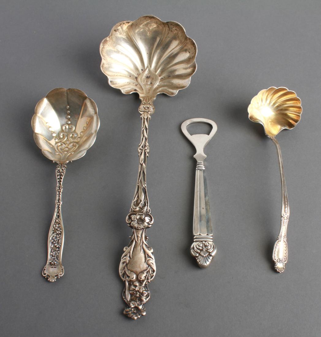Silver Serving Utensils Incl Tiffany & Co. Group 4: Group of four sterling silver serving utensils, comprising a ladle partially gold washed, marked, "Tiffany & Co. Sterling," a large Art Nouveau "Lily" pattern ladle, marked: "Sterling," a repousse ser