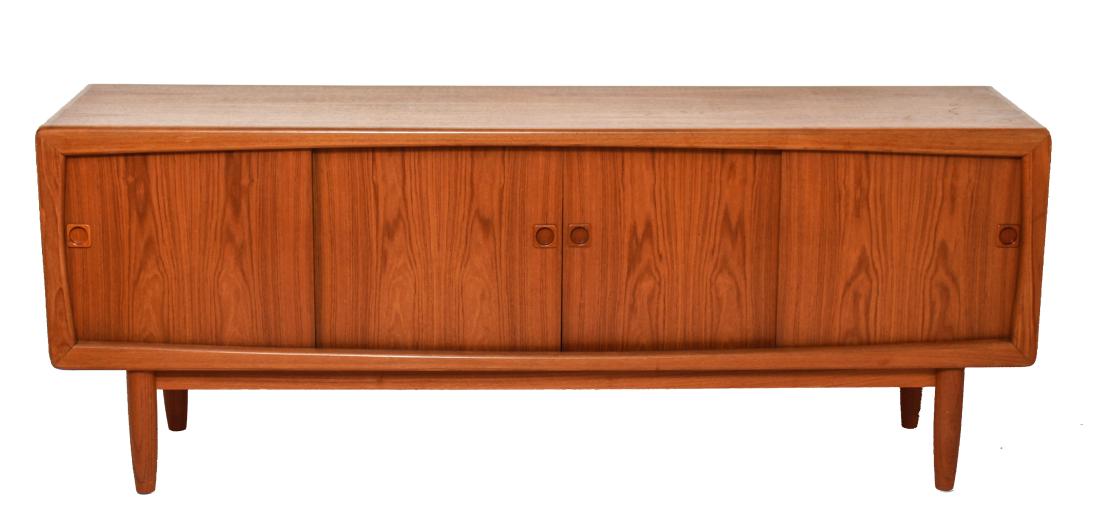 Danish Mid-Century Modern Teak Credenza/Sideboard: Danish mid-century modern teak credenza / sideboard, four sliding doors revealing set of three green felt lined drawers at center, flanked by shelving / storage, raised on four cylindrical legs, stamp
