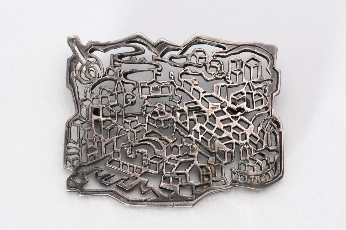 David-Andersen Silver Brooch, Pierced w. Cityscape: David-Andersen sterling silver pin, an openwork panel with piercing depicting an urban cityscape, possibly Oslo, Norway; marked "D-A 925S" on reverse. 1.75" H x 2" W. Approx. 0.4 ozt.