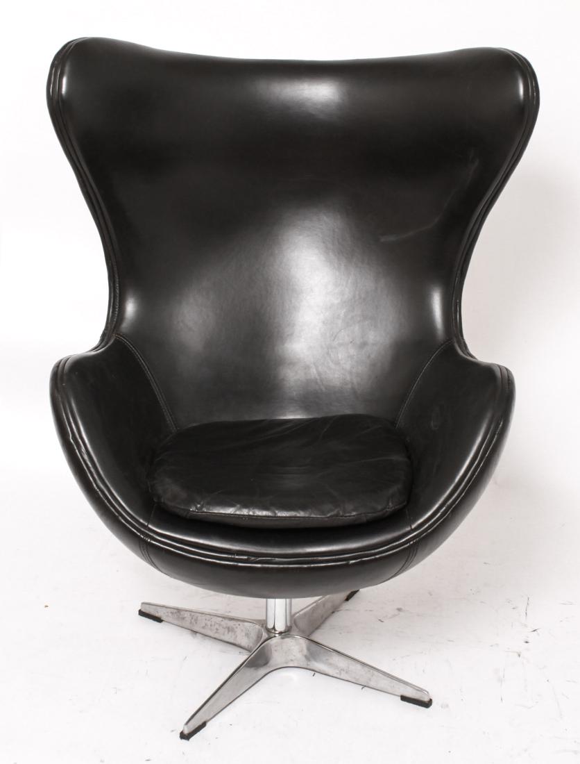 Arne Jacobsen Manner "Copenhagen" Leather Chair: Arne Jacobsen manner "Copenhagen" arm / lounge chair, black leather upholstery, chrome swivel base, originally designed by Arne Jacobsen "Egg Chair" for Fritz Hansen, label underneath: "Made for Resto