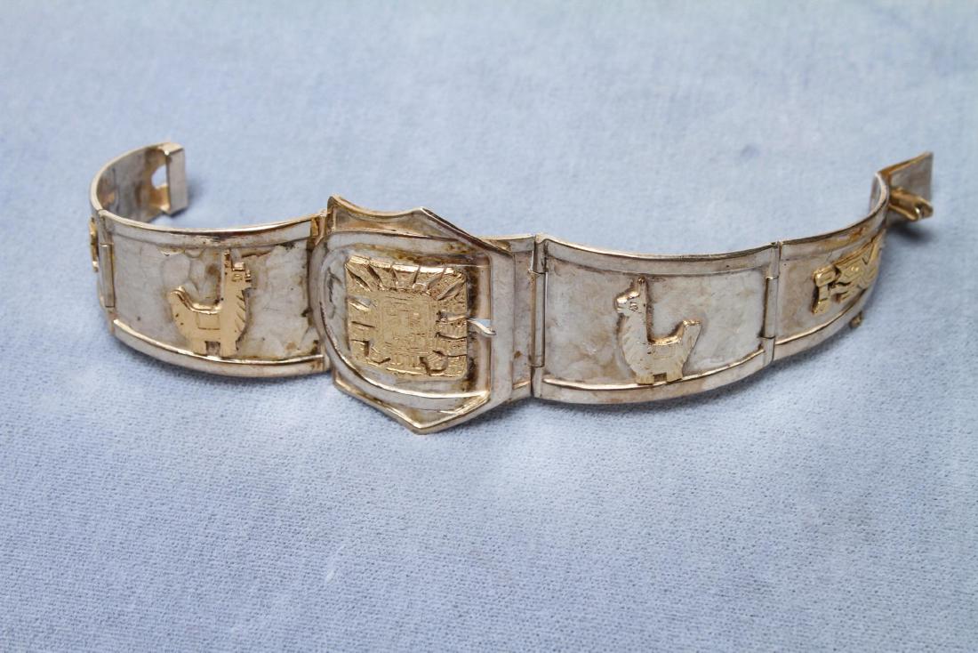 Peru Sterling & 18K Gold Hinged Bracelet: Peruvian sterling & 18K gold hinged bracelet with sun, llamas and birds motifs in 18k gold vermeil, marked, "18K 925 Sterling JFG Peru MR" 7" L. Approx. 1.45 ozt.