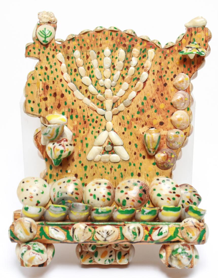 Judaica Shell-Clad Folk Art Menorah: Judaica shell-clad folk art menorah, painted shells applied to wooden base. 9" H x 7" W. From the Collection of Actor Ron Rifkin.