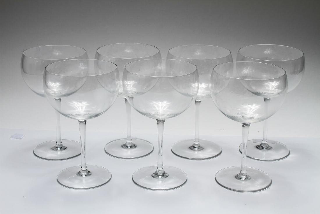 Baccarat Crystal Wine Colorless Glasses Set of 7: Baccarat crystal red wine colorless glasses, marked with Baccarat logo, set of seven. 7" H. From the Collection of Actor Ron Rifkin.