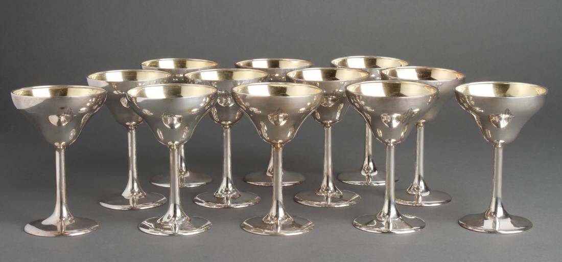 Frank W. Smith Co Inc. Silver Stemmed Aperitifs 12: Set of twelve Frank W. Smith Co. Inc. sterling silver stemmed cordials / aperitifs, gold washed interior, Art Deco monogram, maker's mark and marked: "Sterling / 3706." 4.25" H. Approx 18.54 ozt.