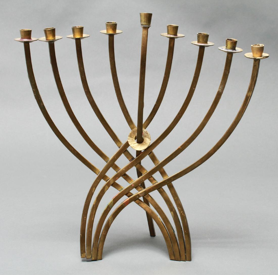Ludwig Wolpert Manner Modern Brass Menorah: Ludwig Wolpert manner Judaica modern brass menorah. 11.25" H x 10.5" W. Replaced bobeche. From the Estate of fashion executive Margot Rogoff.