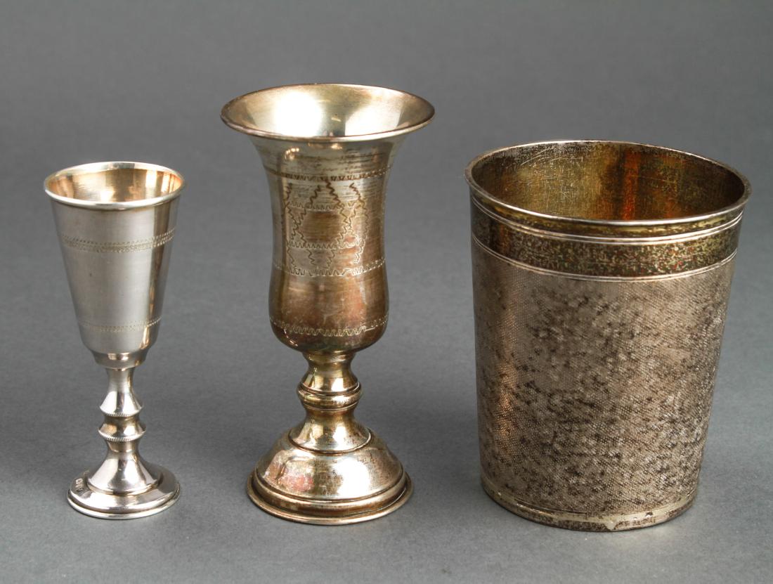 Judaica Silver 2 Kiddush Cups & Beaker Group 3: Group of three Judaica sterling silver two kiddush cups, one marked, "Sterling," and the other, maker's mark: J Zeving (or Joseph Zweig) and hallmarked, : "England / Chester / 1919," and a silver beak