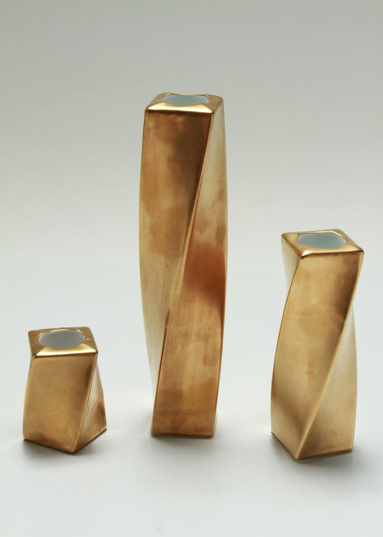Angela Cummings Gilt Porcelain Candlesticks, 3: Angela Cummings gilt porcelain candlesticks, group of three, marked underside. Tallest: 7.25" H.