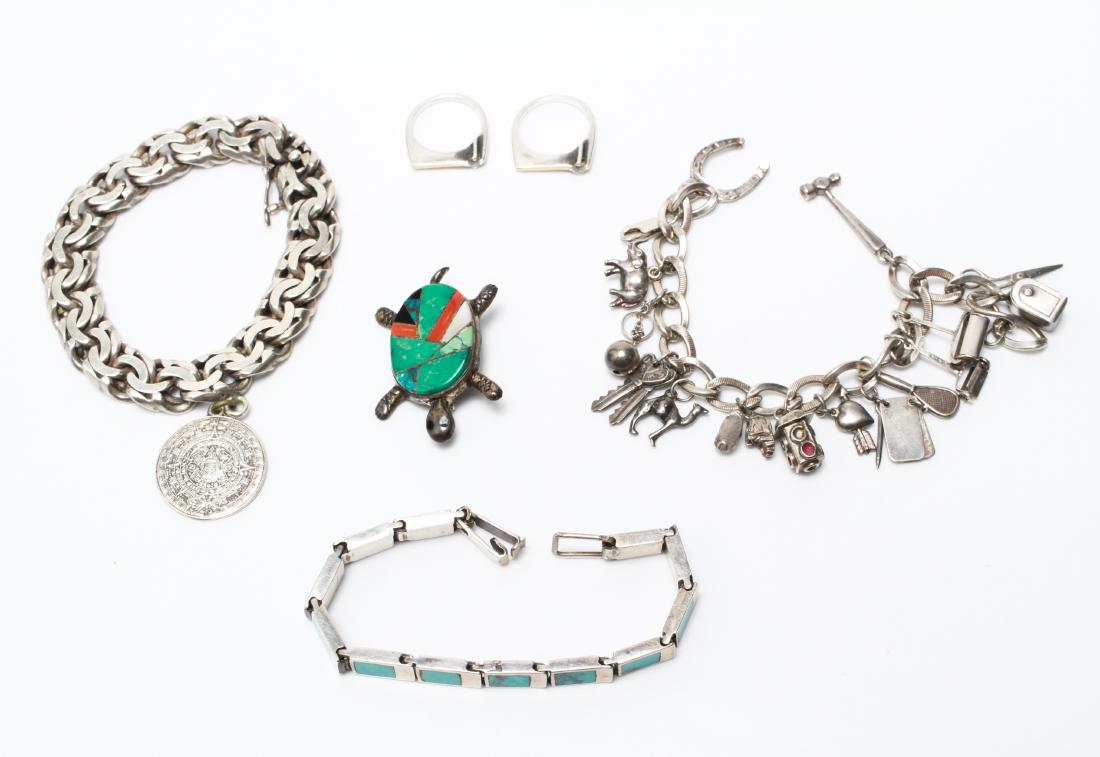 Silver Bracelets Rings & Brooch Group of 6: Group of six, sterling silver jewelry, comprising a charm bracelet marked : "925," a silver and turquoise linked bracelet, a bracelet with Mayan calendar pendant, marked: "FV / Sterling / Taxco," two 