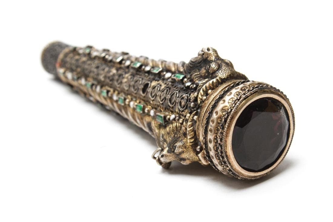 Silver Gilt Emeralds Pearls & Amethyst Cane Handle: Silver-gilt cane / walking stick handle with three figural goat heads with bells and pierced floral motif, emeralds, pearls and a large faceted amethyst hinged lidded compartment, circa 1890. 5.125 L.