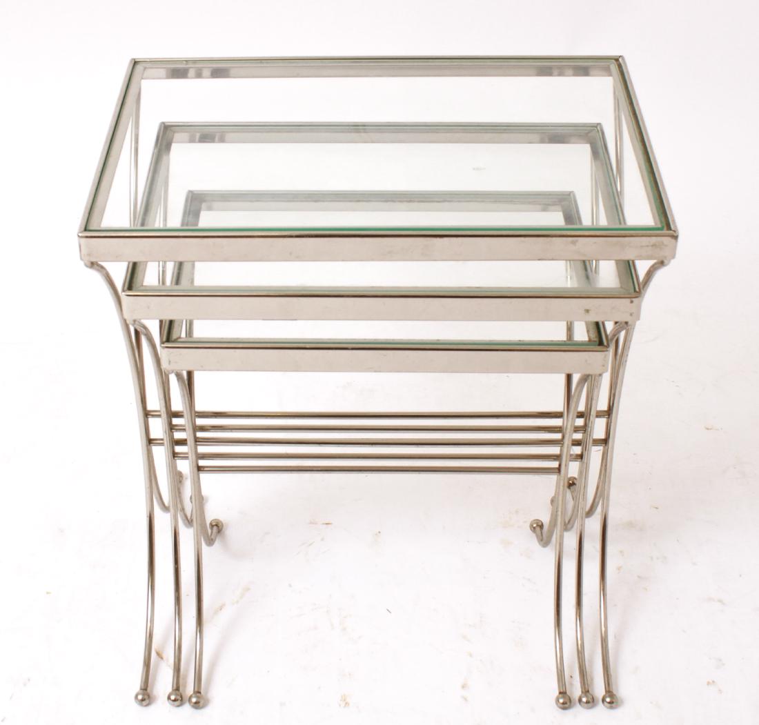 Mid-Century Modern Chrome & Glass Nesting Tables 3: Group of three mid-century modern nesting side tables with chrome metal frames and inset with rectangular glass tops. Largest: 21.25" H x 18.5" W x 12.5" D.