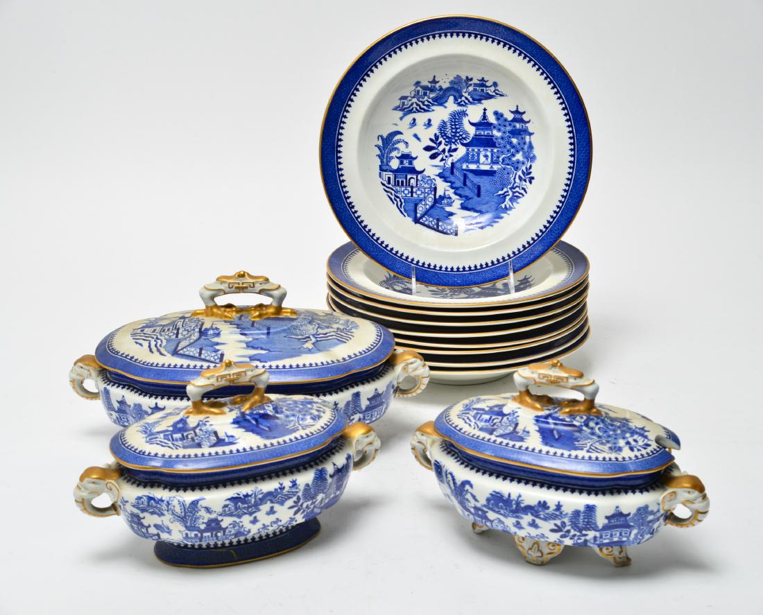 Royal Worcester 3 Tureens & 9 Bowls Group of 12: Group of twelve Royal Worcester Blue Willow with elephant handles, bird feet finials and gilt trim, comprising three tureens and nine soup bowls, marked: "Royal Worcester Vitreous / England." Largest