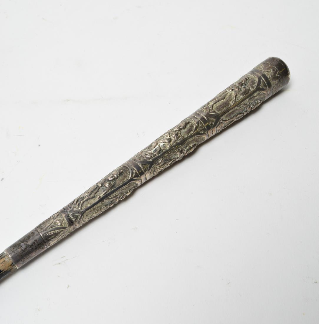 Southeast Asia Silver & Wood Cane / Walking Stick: Southeast Asia silver repousse figures and ebonized wood cane / walking stick with metal ferrule, marked: "T.90." 36" L. Silver tested; not weighable. Wear and scratches to wood surface.