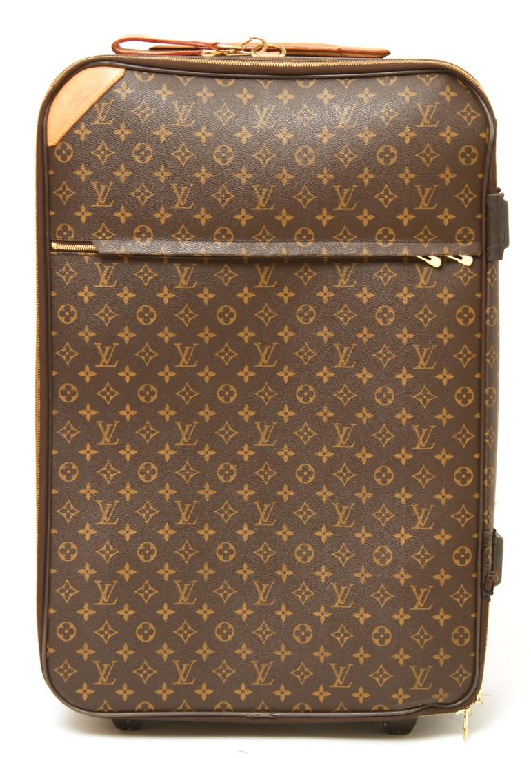 Louis Vuitton Monogrammed Rolling Suitcase: Louis Vuitton monogrammed rolling travel luggage / suitcase, front label marked "Louis Vuitton Paris Made in France." 27" H x 18" W x 9" D. Usage wear including missing zipper pull, damage to rubber a