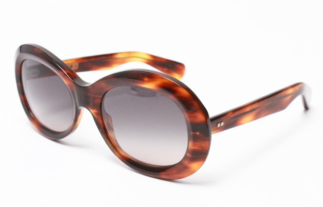 Marni Ladies' Tortoise Shell Designer Sunglasses: Marni ladies' designer sunglasses, tortoise shell frames, marked " Marni / Made in Italy," with green hard storage case. 5.5" W.