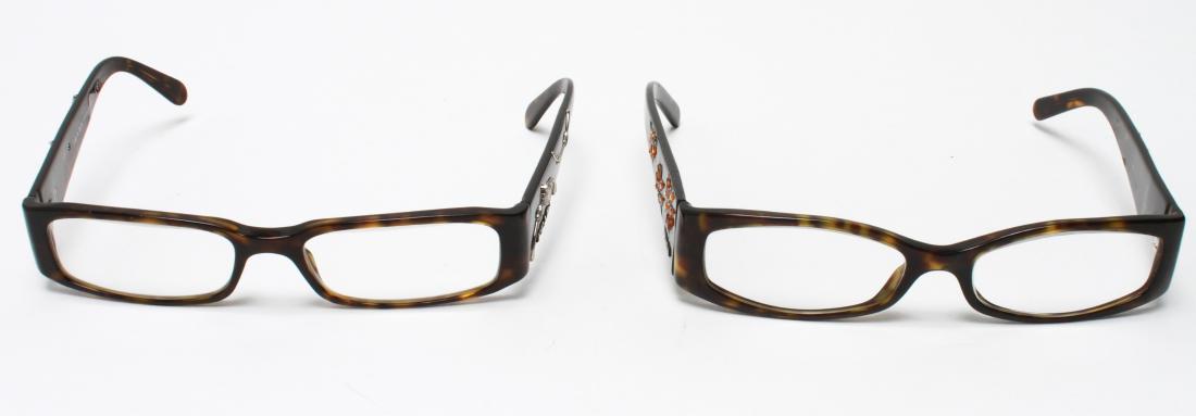 Prada Ladies' Designer Eyeglasses, 2 Pair: Prada ladies' designer eyeglasses, both with tortoise shell frames, one with rope and knot motif, the other with floral motif, both fully marked, both with prescription lenses. 5" W. Gentle usage wear