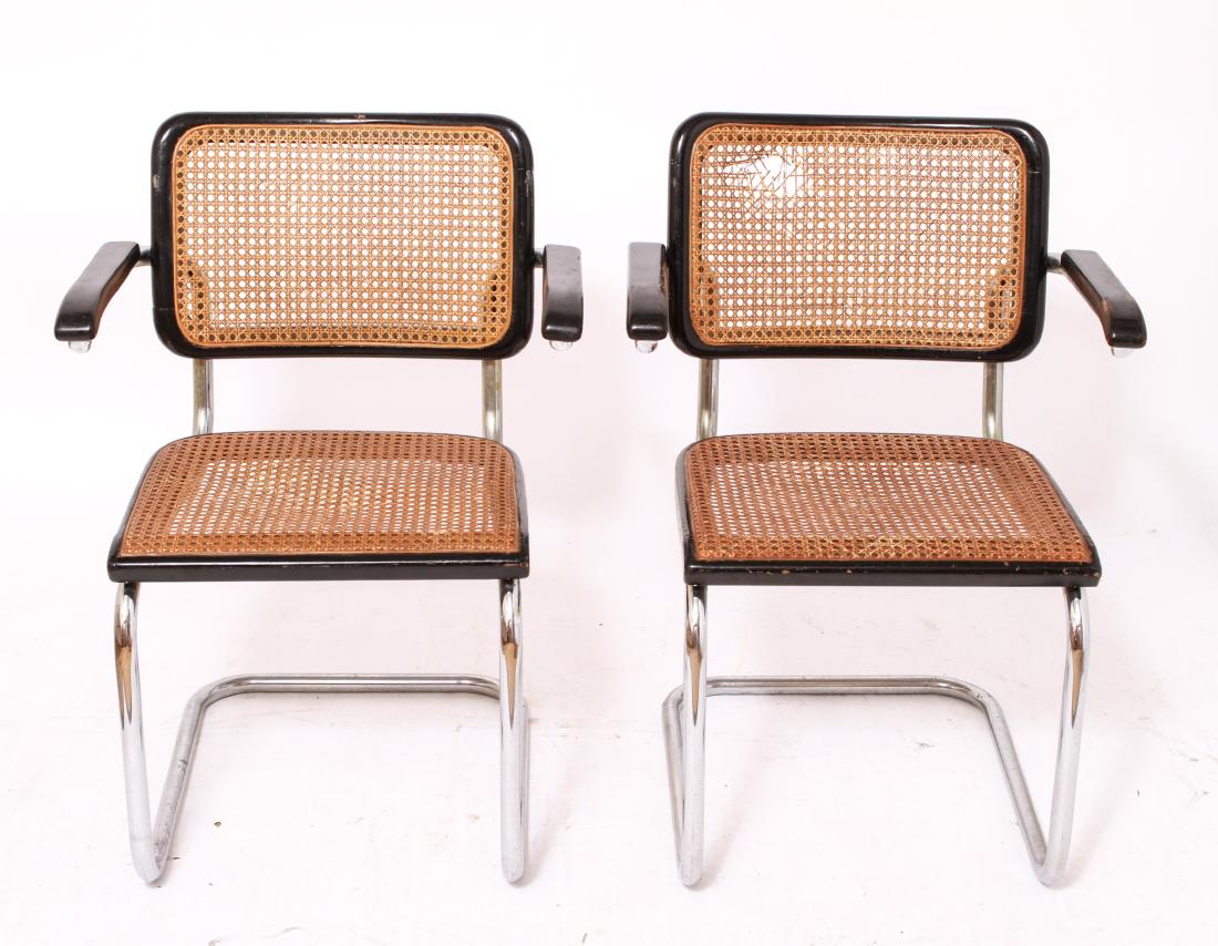 Marcel Breuer 'Cesca' Modern Arm Chairs, Pair: Pair of Marcel Breuer 'Cesca' modern arm chairs, circa 1970, chrome / chromed metal and wood, caned seats and backs. 31" H x 22.5" W x 22" D. Minor surface wear and abrasions, hole in one caned back.