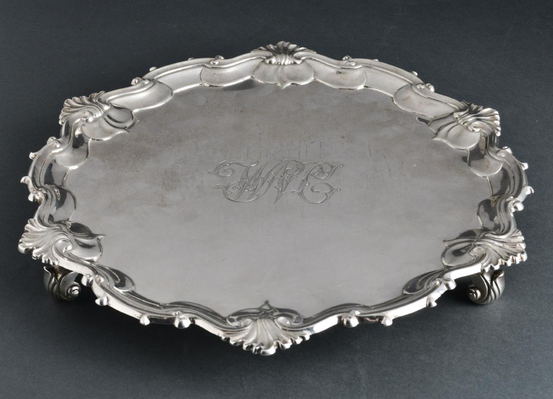 William Grundy English Georgian Silver Salver 1754: William Grundy English Georgian sterling silver footed salver with shaped shell motif border on scroll feet, monogrammed, hallmarked: "W.G. / London / England / 1754," 18th century. 1.75" H x 12.75" d