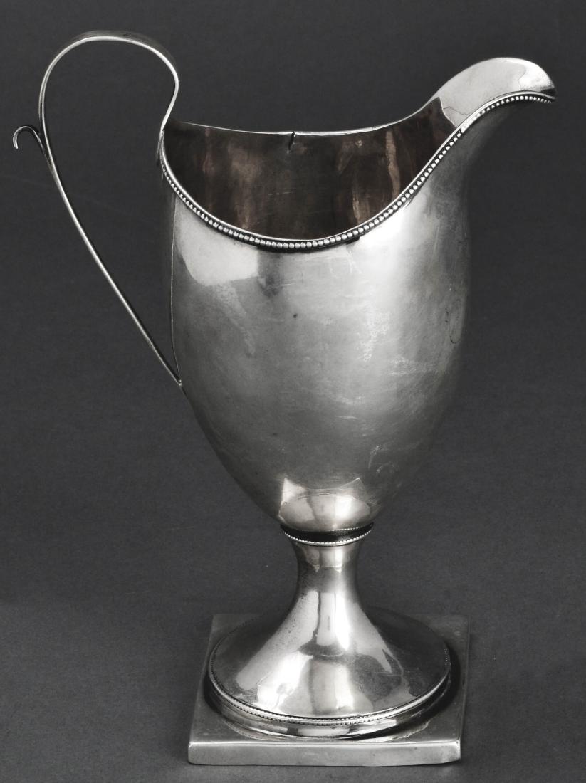 Robert Swan Coin Silver Cream Pitcher Jug C. 1800: Robert Swan, Philadelphia, early American coin silver cream pitcher / jug, marked: "R. Swan," circa 1800. 7" H x 5.25" W x 3.25" W. Approx 4.1 ozt. Minor split at top rim.